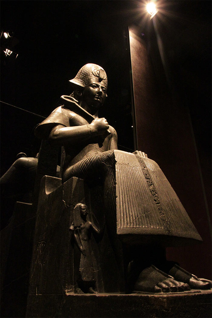 A statue sitting on throne at the Egyptian Museum lit by latest technology LEDs by Philips Lighting