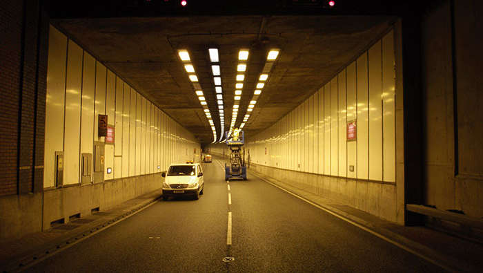 Workers maintaining tunnel lighting