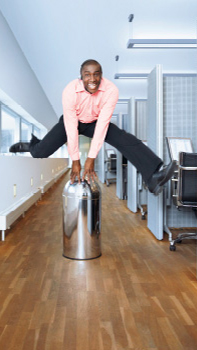 Man is jumping in a corridor of an office illuminated with Philips dynamic lighting