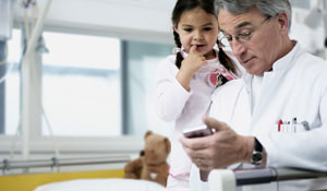 A doctor and a child under Philips lighting that helps a hospital’s staff to be happier and more productive