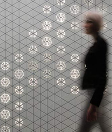 Woman walks past an interior wall decorated with Philips Luminous Patterns - customer experience