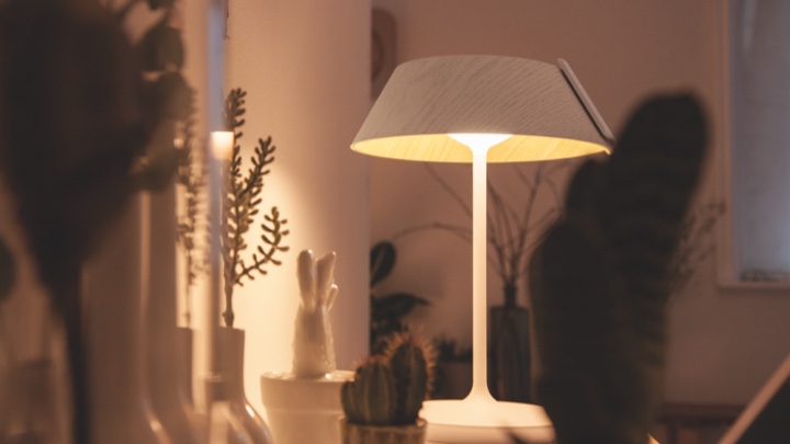 Table lamp lighting a living room cabinet