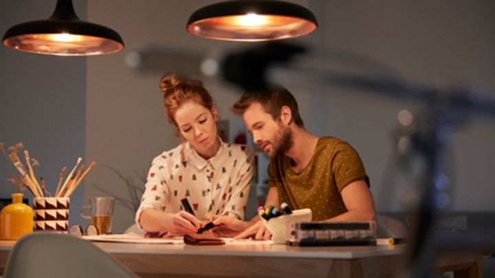 two people creating a light plan at a well lit desk