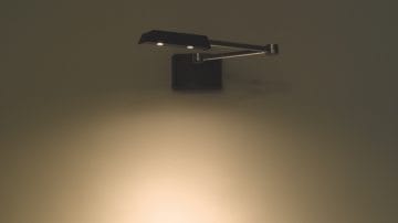 An adjustable lamp mounted at a wall